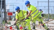 Les ouvriers travaillent parfois encore à la fourche pour construire de nouvelles voies de chemin de fer Les ouvriers travaillent parfois encore à la fourche pour construire de nouvelles voies de chemin de fer