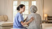 Nurse listening to chest of patient in home Nurse listening to chest of patient in home