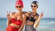 two young woman posing together on beach two young woman posing together on beach