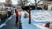 young girl putting letter in mail box young girl putting letter in mail box