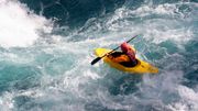 Kayaker maneuvers over rough waters Kayaker maneuvers over rough waters