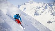 Full length of man skiing on mountain slope Full length of man skiing on mountain slope