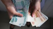 An employee holds 1000 and 500 ruble banknotes An employee holds 1000 and 500 ruble banknotes