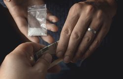 Addict man with money buying dose of cocaine or heroine or another narcotic from drug dealer. Drug abuse and traffic concept Addict man with money buying dose of cocaine or heroine or another narcotic from drug dealer. Drug abuse and traffic concept